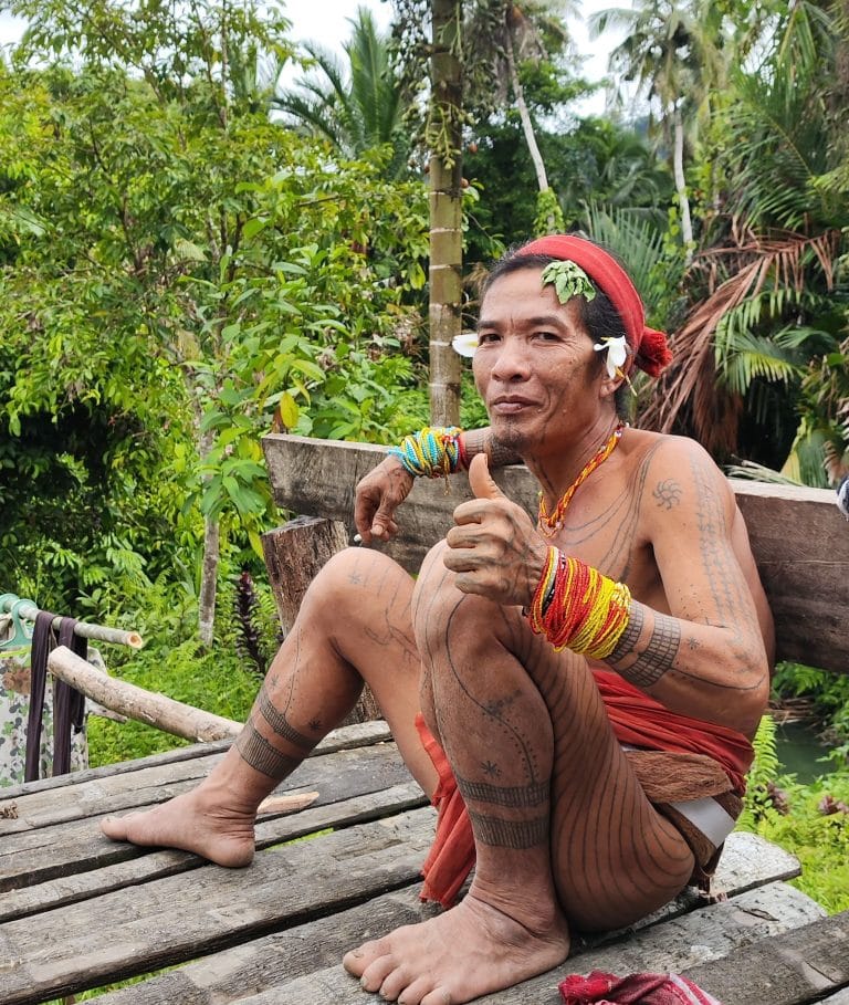 Mentawai Sikerei shaman welcoming guests on Siberut Island