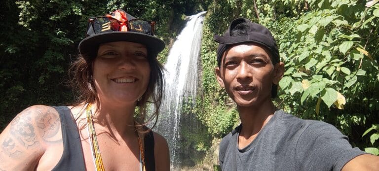 Tour guest and local guide taking a selfie together at a Siberut jungle waterfall