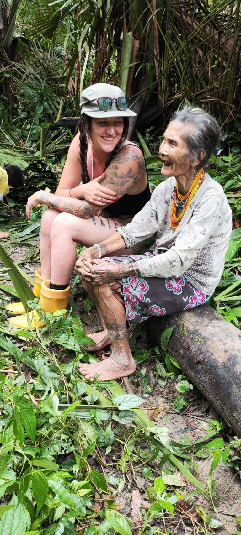 Tour guest bonding with an elderly Mentawai woman in the Siberut jungle