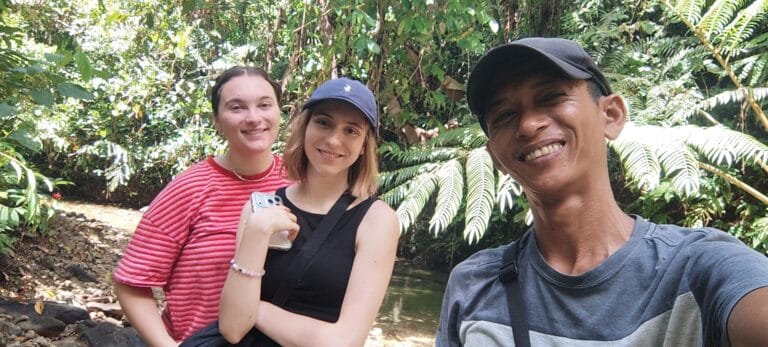 Tour guests and their local guide taking a selfie during a Siberut jungle trek
