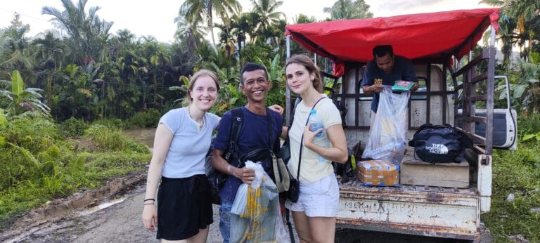 Tour guests arriving with their guide and luggage transport in Siberut