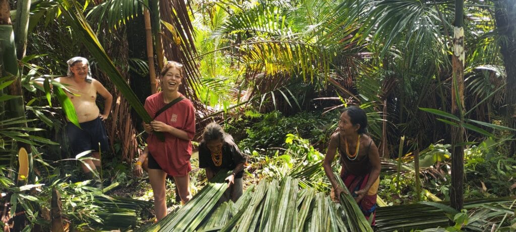 Tour guests harvesting palm leaves alongside the Mentawai community in Siberut