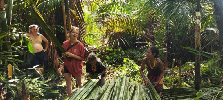 Tour guests harvesting palm leaves alongside the Mentawai community in Siberut