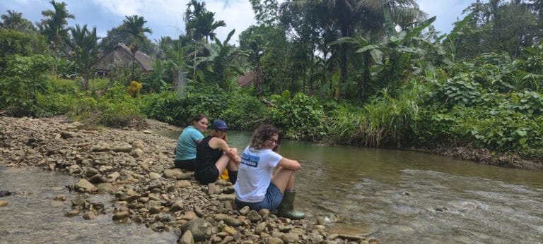 Tour guests relaxing by the river in a Mentawai village in Siberut