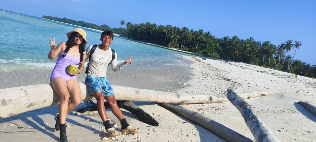 Tour guests relaxing on a tropical beach in the Mentawai Islands