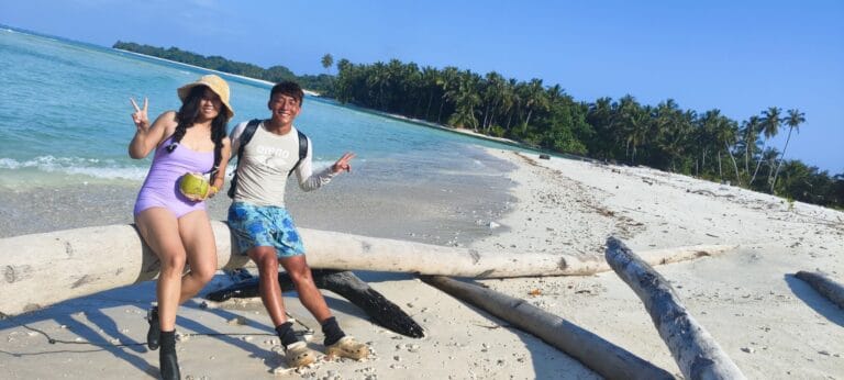 Tour guests relaxing on a tropical beach in the Mentawai Islands