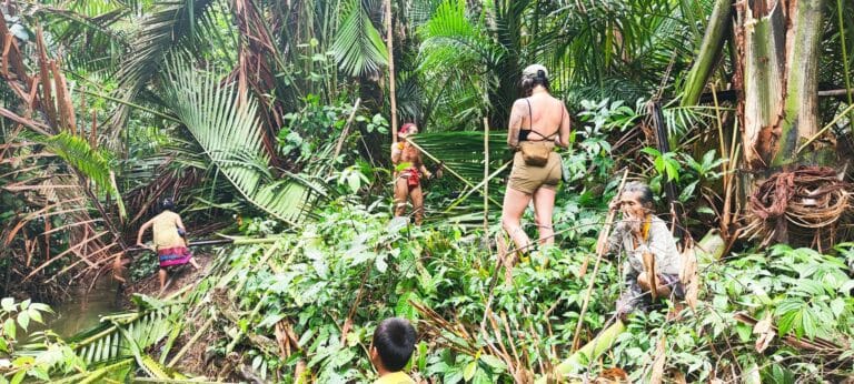 Tour guests trekking through the Siberut jungle together with the local Mentawai community