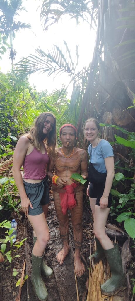 Tour guests walking with a Mentawai Sikerei through the Siberut jungle forest