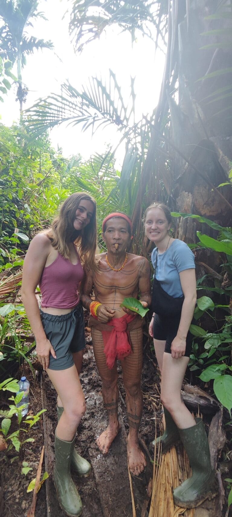 Tour guests walking with a Mentawai Sikerei through the Siberut jungle forest