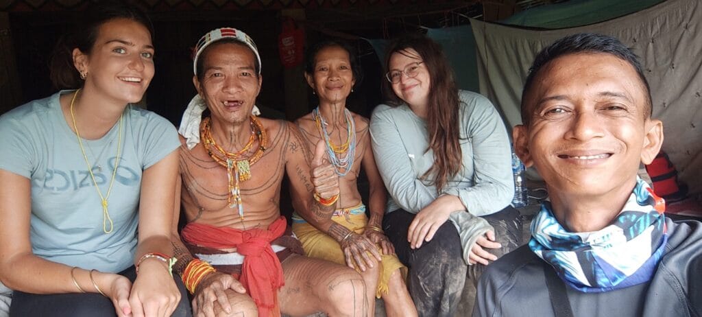 Andrian Salis with guests Olivia and Nam from the UK alongside a Mentawai Sikerei shaman and his wife in Siberut village