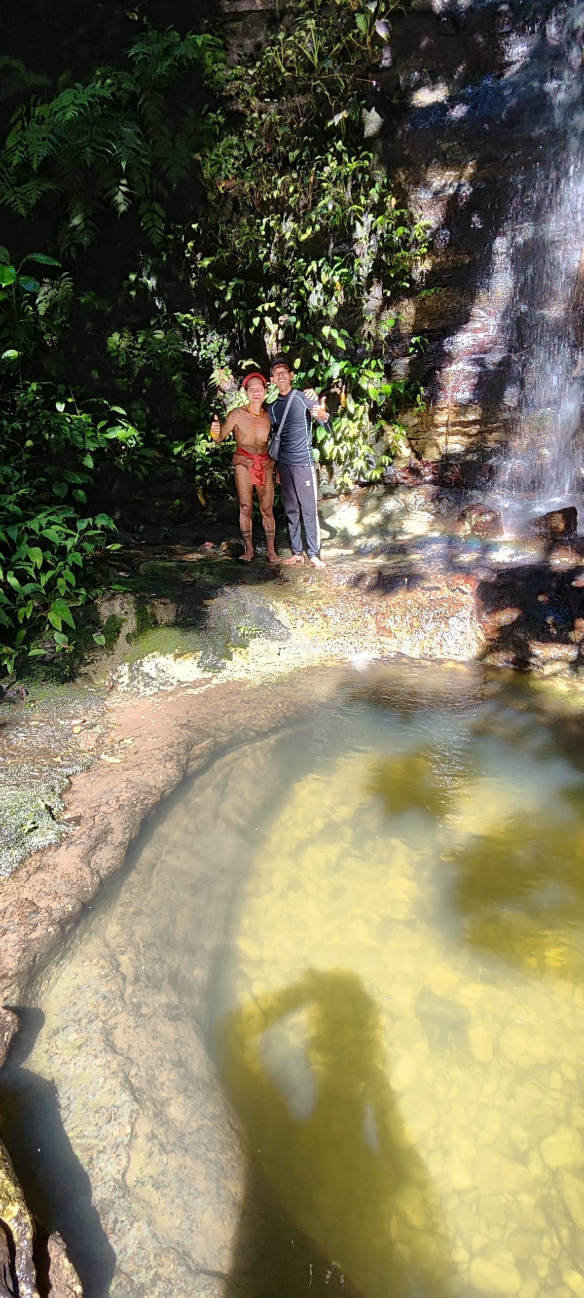 Andrian Salis and Sikerei at a natural jungle pool, Mentawai