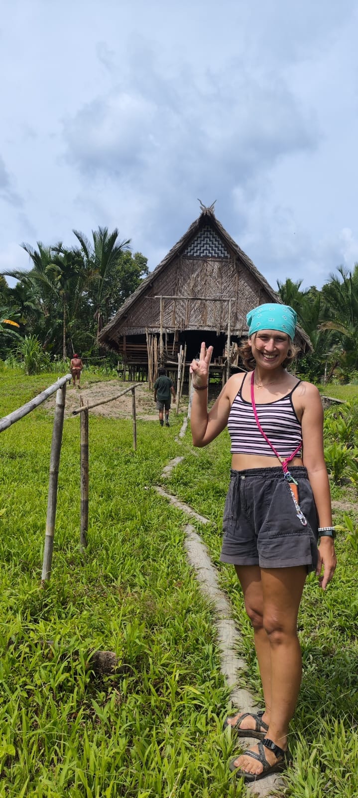 Guest with full exterior view of traditional Uma longhouse architecture