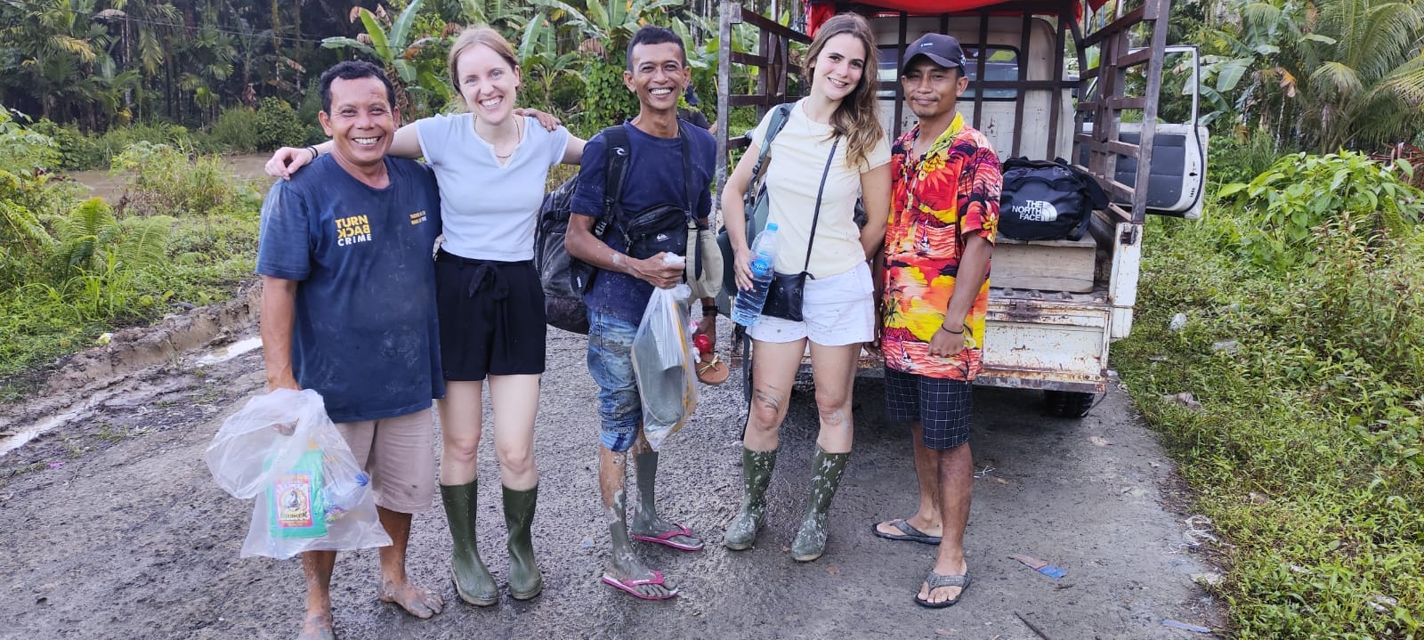 Guests and guides group photo at the end of the trek by truck, Mentawai