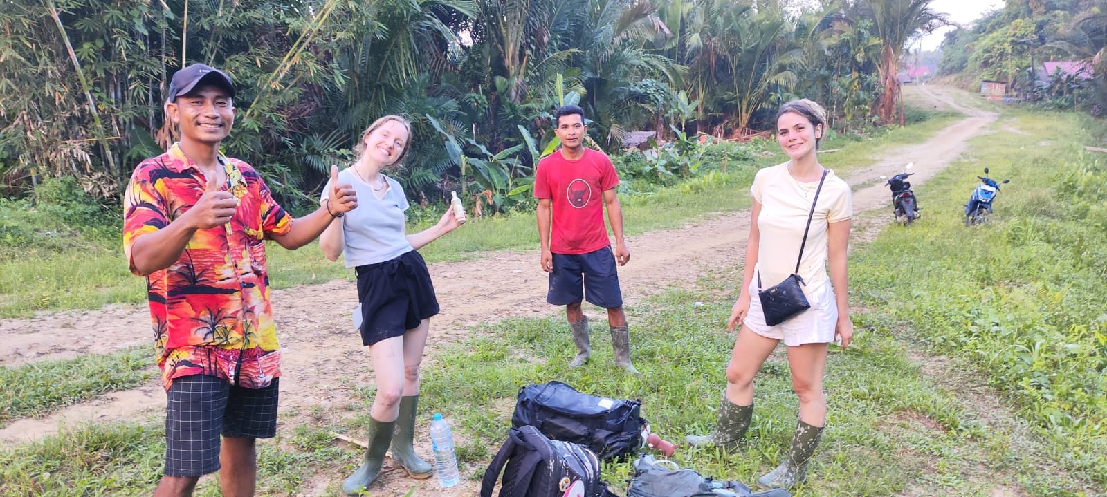 Guests and guides group photo at the start of the trek on a village road, Mentawai