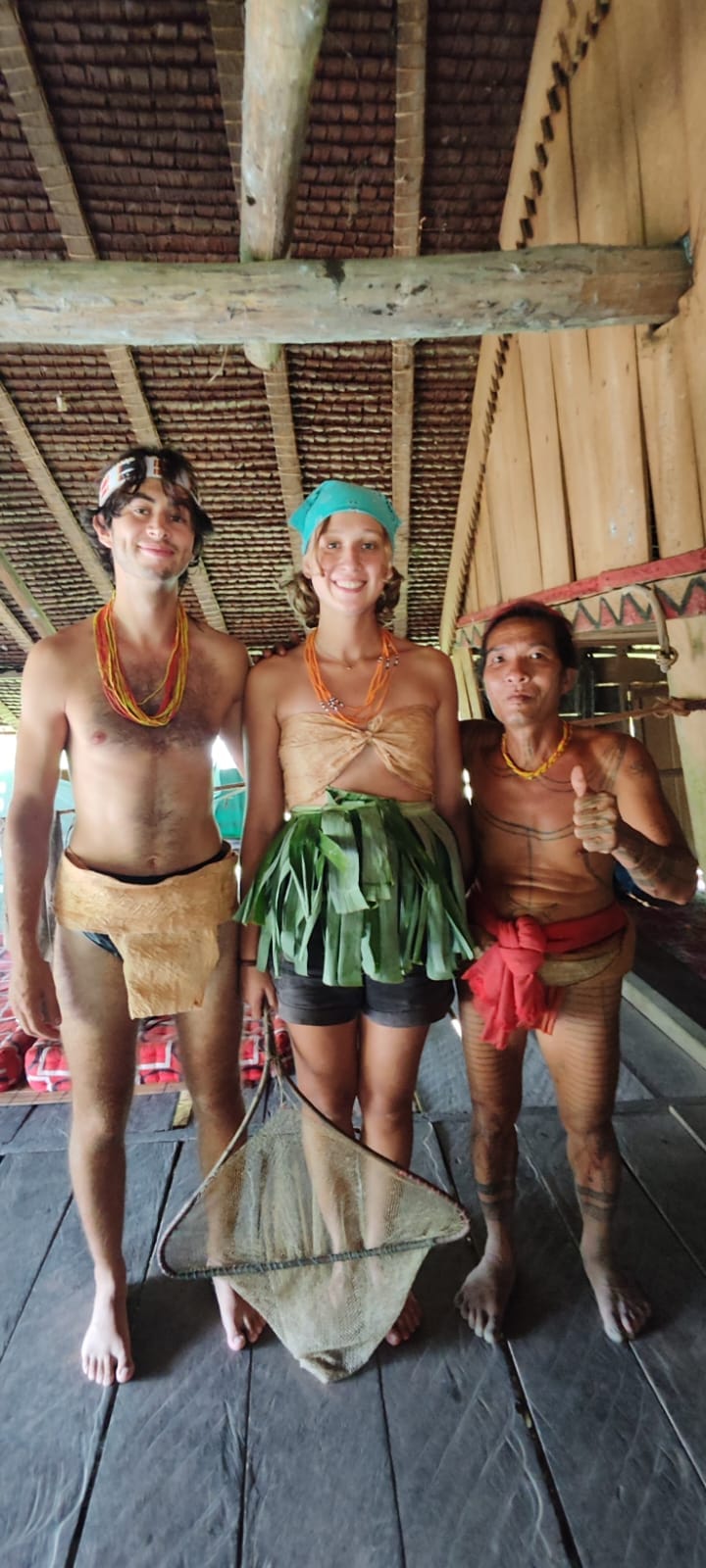Guests dressed in traditional Mentawai costume with Sikerei inside Uma