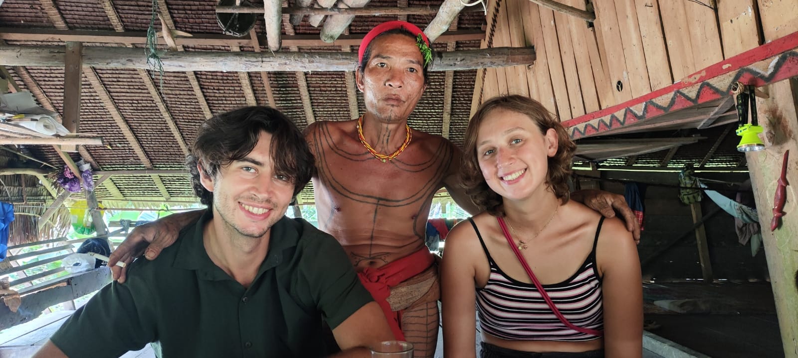 Guests taking a selfie with a tattooed Sikerei inside Uma