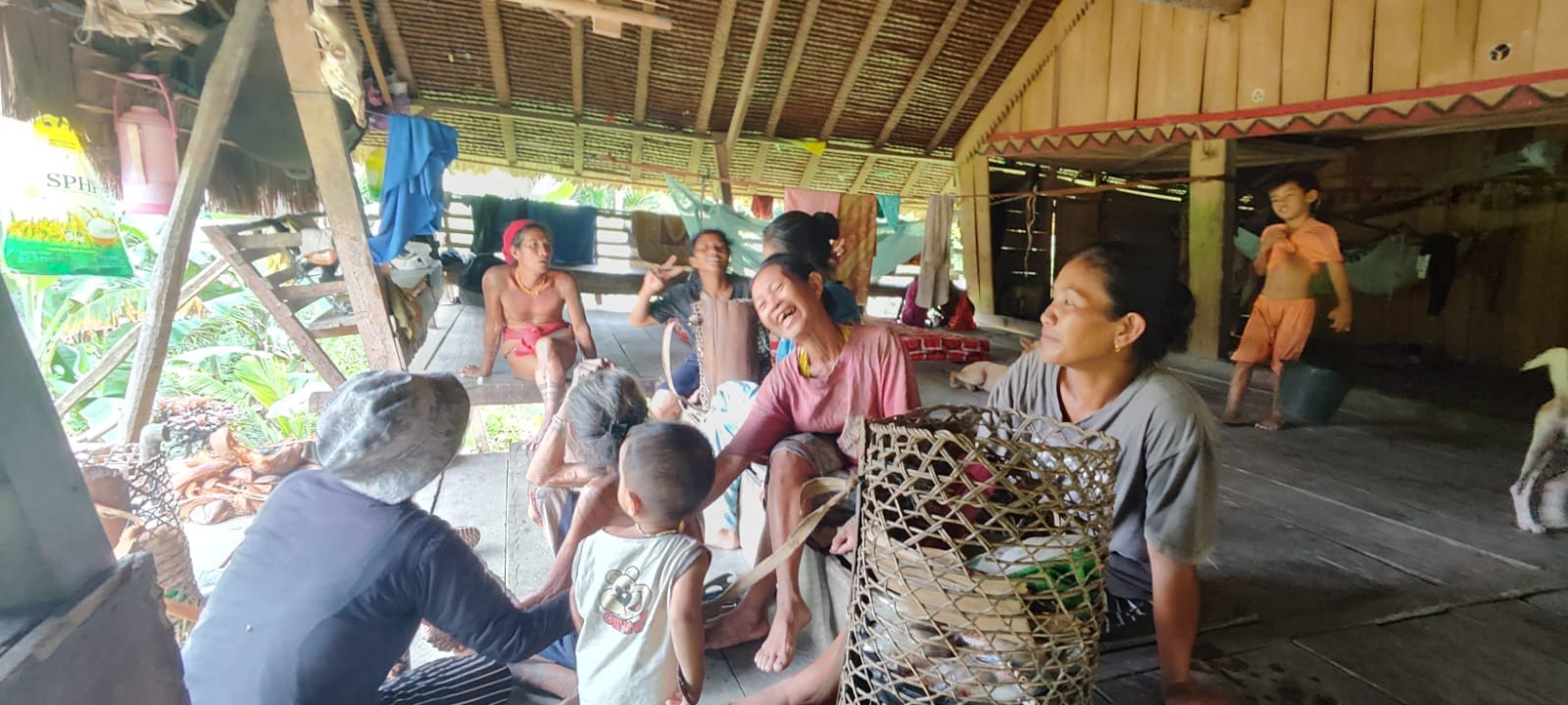 Mentawai family daily life inside Uma longhouse interior
