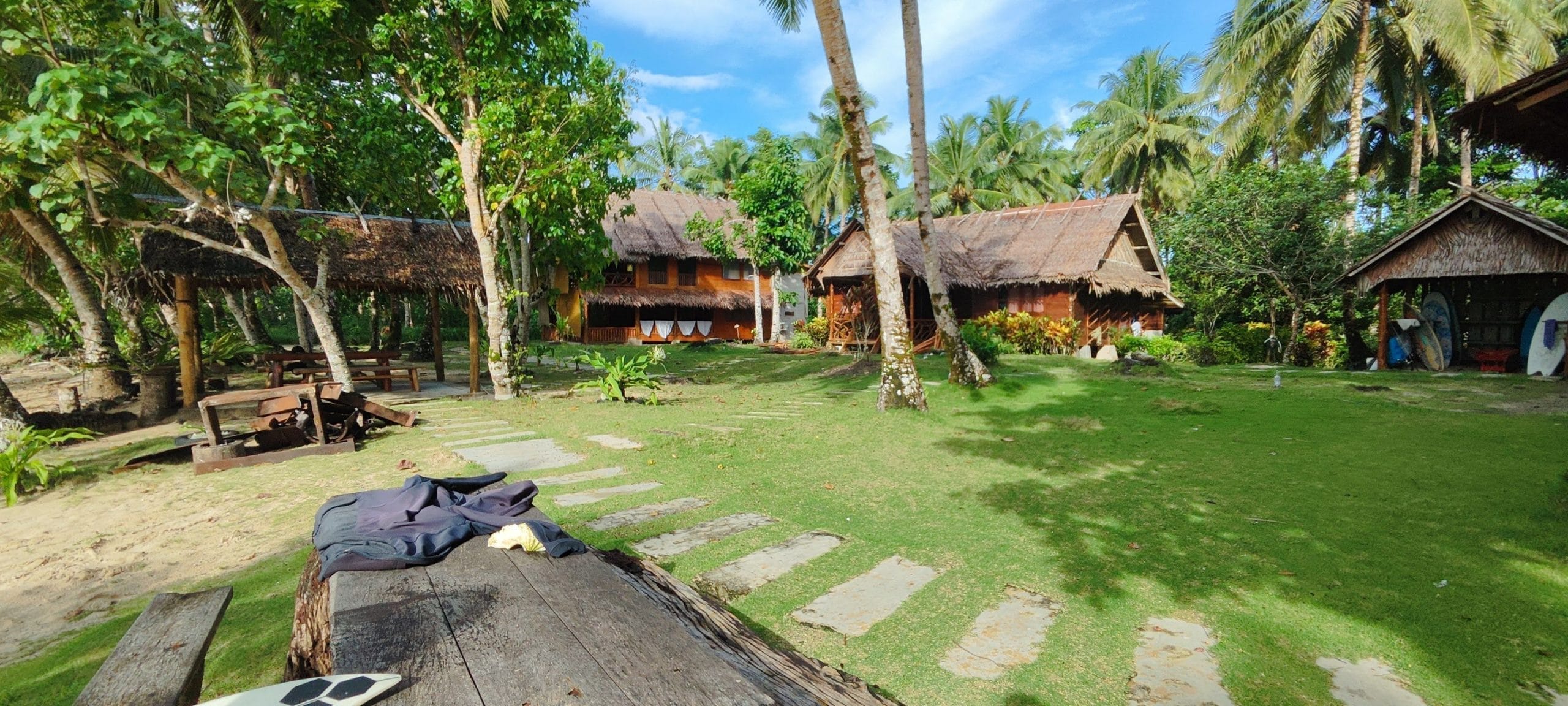 Mentawai surf camp grounds with bungalows and palm trees