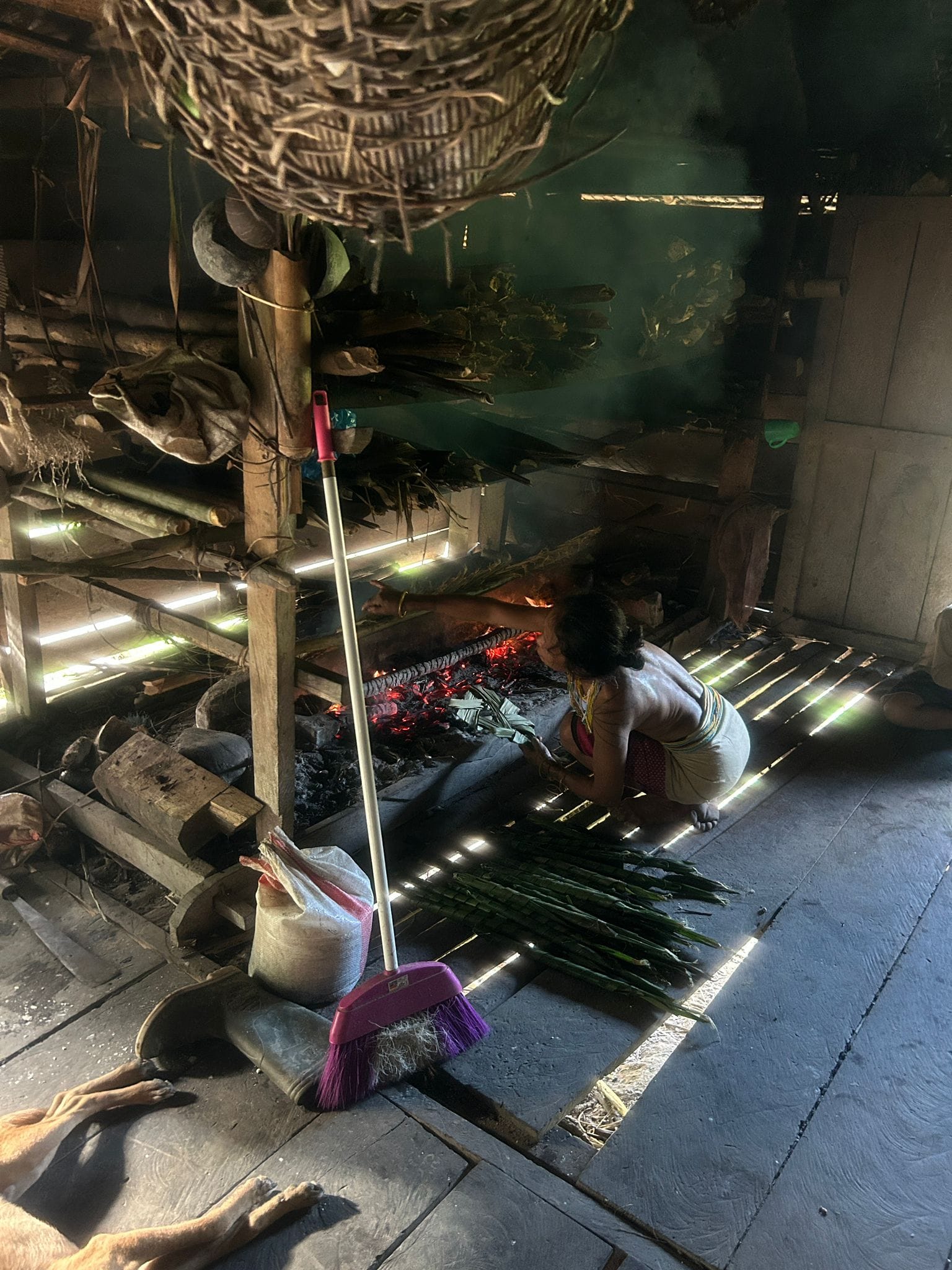 Mentawai woman tending the fire hearth inside Uma