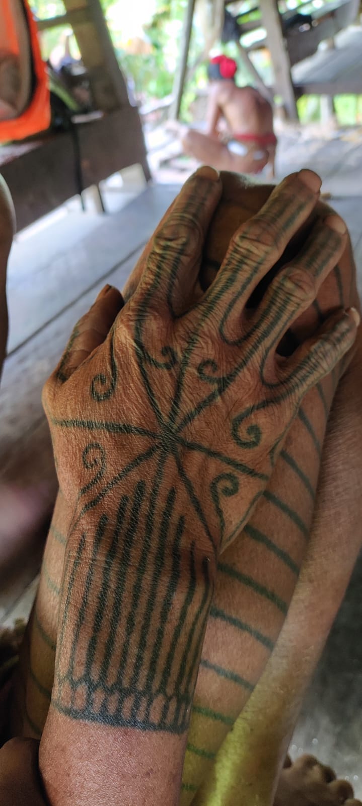 Close-up of Sikerei hand tattoo with spiral pattern