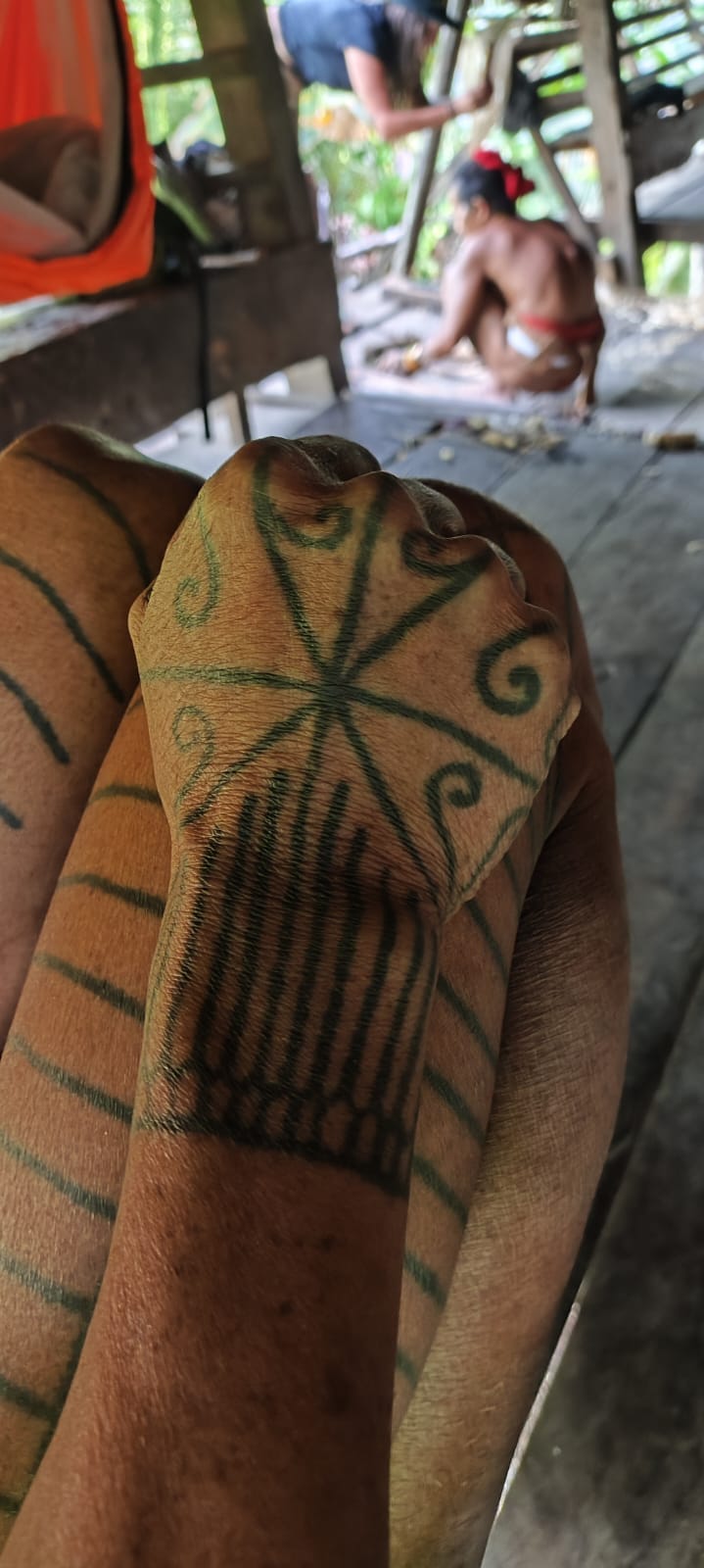Close-up of traditional Mentawai arm and hand tattoo on Uma porch