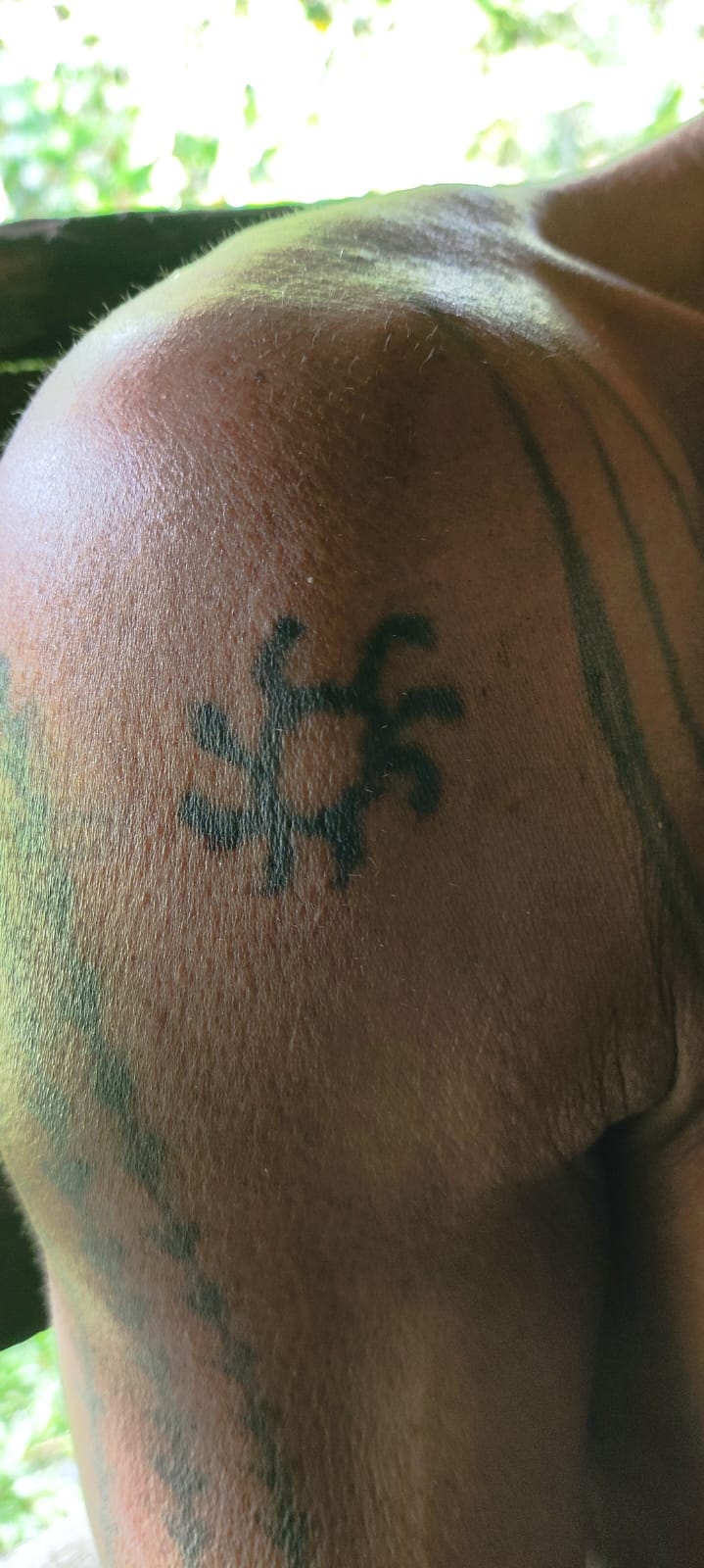 Traditional Mentawai star motif tattoo on shoulder, close-up