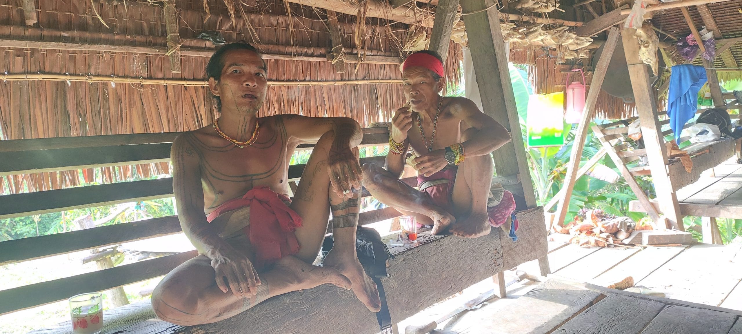 Two Sikerei relaxing on the Uma porch, Mentawai